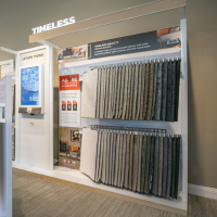 Carpet samples arranged from light to dark tones in a showroom display.